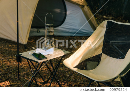 Solo camp with a mask and smartphone 90979224