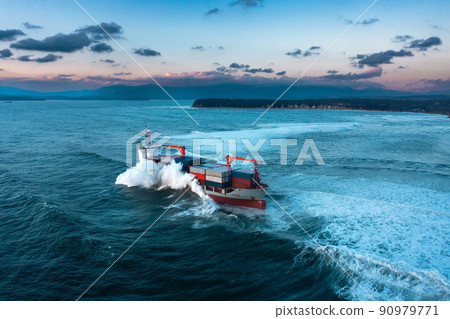 Stormy sea with Container ship delivering cargo at sunset Stormy sea with Container ship delivering cargo at sunset 90979771