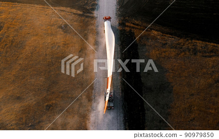 Turbine bladesfor a wind turbine being transported to the construction site by truck 90979850