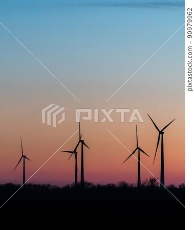 Wind Turbines In Rural Landscape At Sunset. Green renewable and alternative energy concept 90979962
