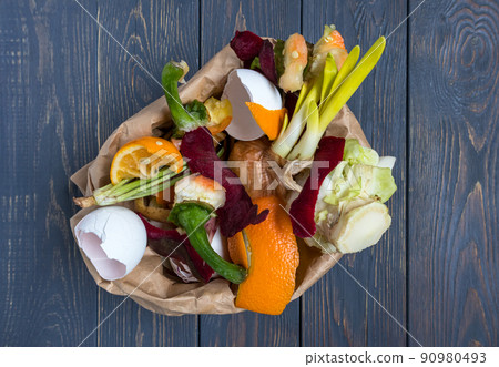 Vegetable and fruit waste from cooking, collected in a garbage bag for recycling. Compost. The concept of zero waste. Vegetable and fruit waste from cooking, collected in a garbage bag for recycling. Compost. The concept of zero waste. 90980493