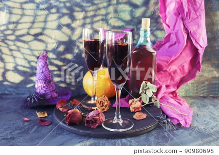 Halloween, wine in glasses and a bottle, pumpkins, mystical decorations, dry rose flowers, on a black background, shadows in the form of a cobweb, the concept of the atmosphere of a party, holiday Halloween, wine in glasses and a bottle, pumpkins, mystical decorations, dry rose flowers, on a black background, shadows in the form of a cobweb, the concept of the atmosphere of a party, holiday 90980698