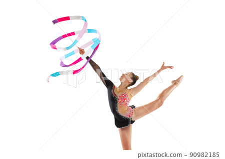 Portrait of young sportive girl, rhythmic gymnastics artist isolated on white studio background. Concept of sport, action, aspiration, education, active lifestyle 90982185