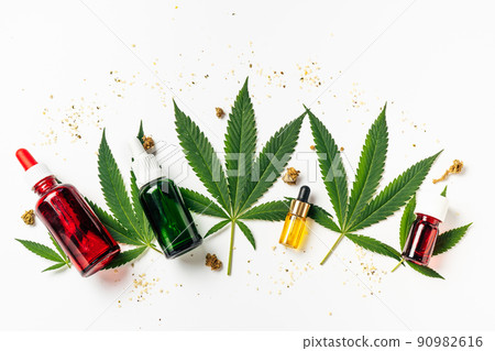 Cannabis oil, hemp leaves, dry flowers and seeds on white background. Natural cosmetics. Increasingly legal and medical use of marijuana 90982616