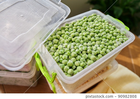 Frozen vegetables and fruits, close-up frozen green peas 90982808