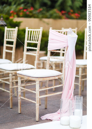 Rows of chairs for the guests at a wedding ceremony 90983584