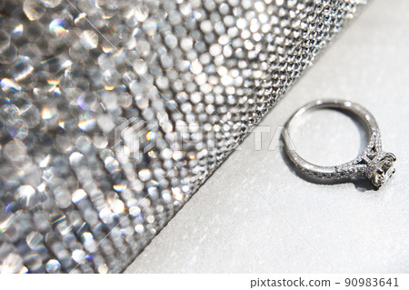 Wedding ring with silver handbag on white table Wedding ring with silver handbag on white table 90983641