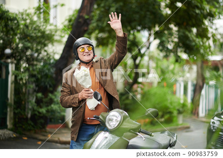 Excited Senior Man Waving to Girlfriend Excited Senior Man Waving to Girlfriend 90983759