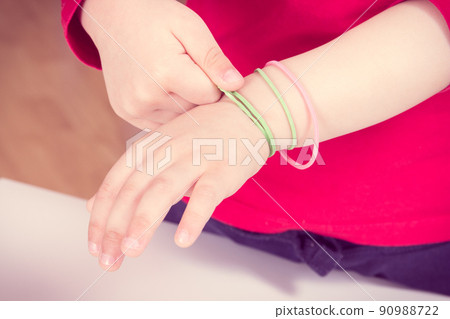 Little boy putting rubber bands or erasers on hand. Best creative game for early fine motor skills 90988722