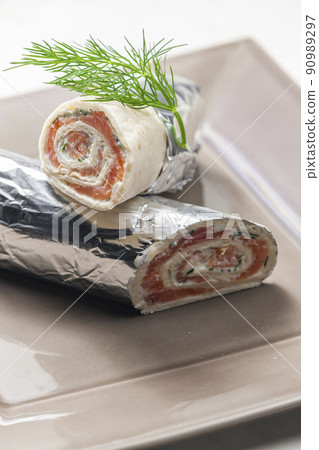 tortilla filled with smoked salmon and dill cream cheese 90989297