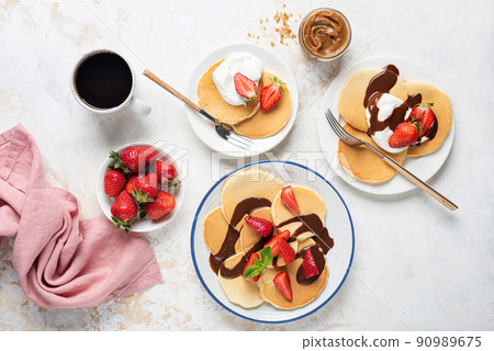 Breakfast pancakes with strawberries, yogurt and chocolate sauce 90989675