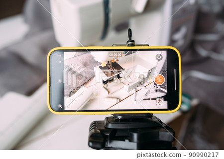 Shooting video of the sewing process, workshop on clothing design on smartphone 90990217