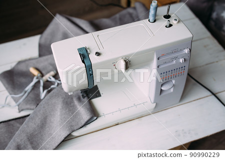 Sewing machine, accessories and fabric. Cozy creative sewing process at home Sewing machine, accessories and fabric. Cozy creative sewing process at home 90990229