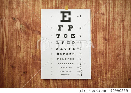 White optometry chart on the wooden wall White optometry chart on the wooden wall 90990289
