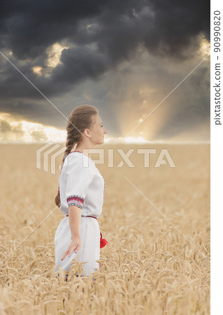 girl in Ukrainian national costume on a wheat field 90990820