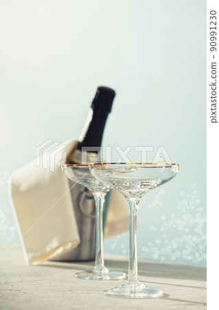 Bottle of champagne and glasses on sea and sky background. Bottle of champagne and glasses on sea and sky background. 90991230