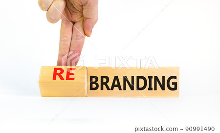 Branding or rebranding symbol. Businessman turns wooden cubes and changes the word Branding to Rebranding. Beautiful white table white background, copy space. Business branding rebranding concept. 90991490