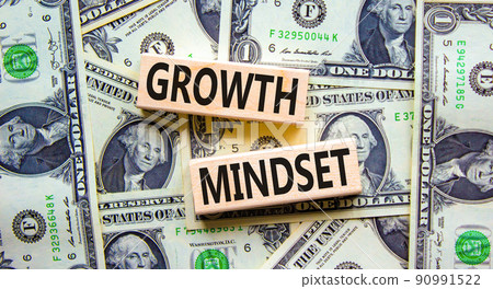 Growth mindset symbol. Wooden blocks with concept words Growth mindset on beautiful background from dollar bills. Business growth mindset concept. Copy space. Growth mindset symbol. Wooden blocks with concept words Growth mindset on beautiful background from dollar bills. Business growth mindset concept. Copy space. 90991522