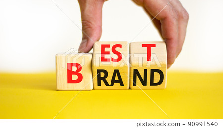 Build your best brand symbol. Concept words Best brand on wooden cubes. Businessman hand. Beautiful yellow table white background. Build your best brand and business concept. Copy space. Build your best brand symbol. Concept words Best brand on wooden cubes. Businessman hand. Beautiful yellow table white background. Build your best brand and business concept. Copy space. 90991540