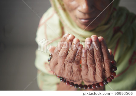 Close up of senior women hand praying at ramadan Close up of senior women hand praying at ramadan 90993566