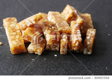 pea nuts sweet bar black background close up pea nuts sweet bar black background close up 90993568