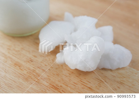 cold oil coconut on a wooden board cold oil coconut on a wooden board 90993573