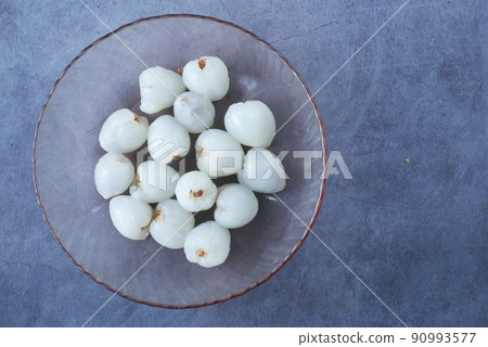 Lychee fruit in a bowl on black background Lychee fruit in a bowl on black background 90993577