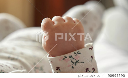 Tiny hand of newborn baby clenched into fist in bedroom Tiny hand of newborn baby clenched into fist in bedroom 90993590