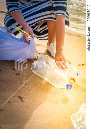 cleaning plastic on the beach. cleaning plastic on the beach. 90995042