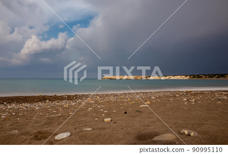 Sandy and pebble beach of the Mediterranean Sea, shot in calm weather at night with a long exposure. Sandy and pebble beach of the Mediterranean Sea, shot in calm weather at night with a long exposure. 90995110