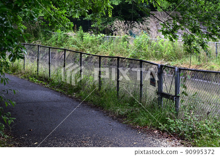 Fence along the irrigation canal Fence along the irrigation canal 90995372