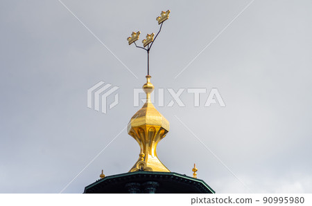 Three crowns - a symbol of Sweden on the dome of a building in Stockholm. 90995980