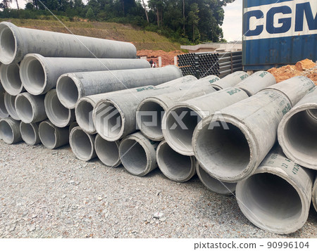 KUALA LUMPUR, MALAYSIA -MAY 13, 2020: Precast concrete culvert at the construction site. The material is shipped by the manufacturer and is ready for installation. Made of reinforced concrete KUALA LUMPUR, MALAYSIA -MAY 13, 2020: Precast concrete culvert at the construction site. The material is shipped by the manufacturer and is ready for installation. Made of reinforced concrete 90996104