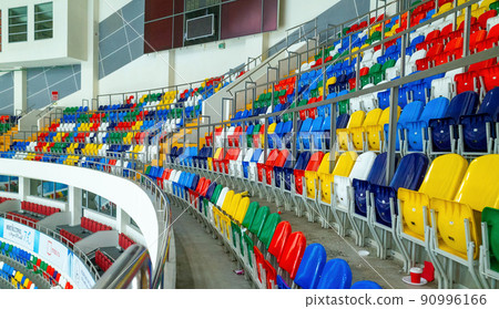 Colorful chairs in the stands of the MEGASPORT sports Palace in Moscow. Colorful chairs in the stands of the MEGASPORT sports Palace in Moscow. 90996166