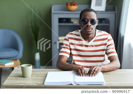 Blind Man Reading Book at Home Blind Man Reading Book at Home 90996917