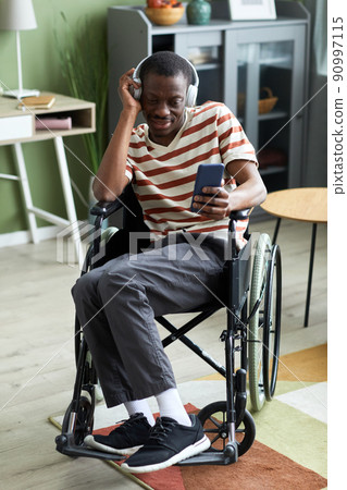 Man with Disability Listening to Music at Home 90997115