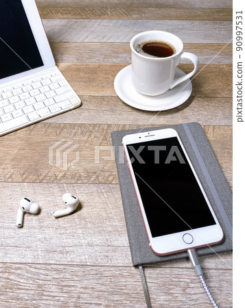 Coffee break tablet PC and smartphone being charged vertically 90997531
