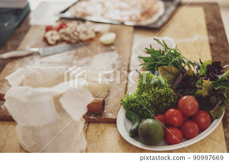 Ingredients for making pizza at home laid out on the table 90997669