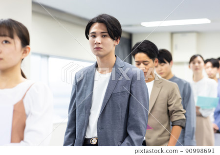 男人和女人排隊等候輪到他們 90998691