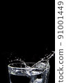 Splashing water on glass on isolated black background  91001449