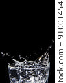 Splashing water on glass on isolated black background 91001454