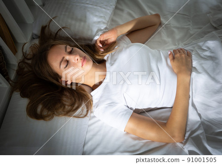 Portrait of blond girl with long hair sleeping in bed Portrait of blond girl with long hair sleeping in bed 91001505