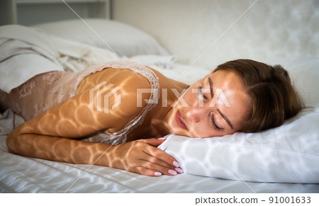 Portrait of blond girl with long hair sleeping in bed Portrait of blond girl with long hair sleeping in bed 91001633