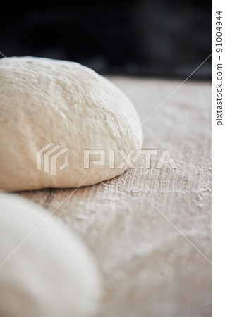 The process of making wheat bread at home. Dough shaping. The concept of healthy homemade food. Vertical photo. The process of making wheat bread at home. Dough shaping. The concept of healthy homemade food. Vertical photo. 91004944