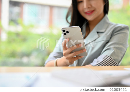 Attractive businesswoman using a smartphone. cropped image 91005431