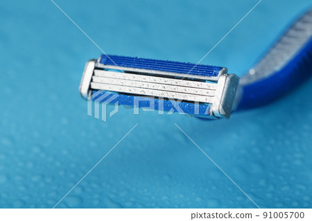 Shaving machine for the face on a blue background top view free space Shaving machine for the face on a blue background top view free space 91005700