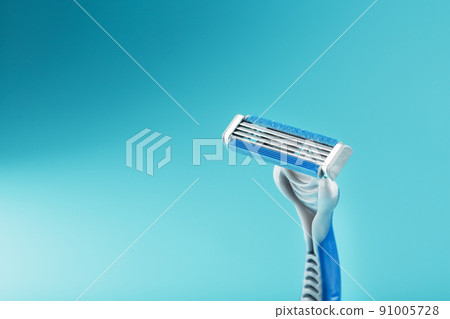 Blades of a new shaving machine on a blue background Blades of a new shaving machine on a blue background 91005728