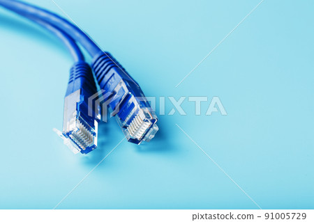 Ethernet Cable connector Patch cord cord close-up on a blue background with free space Ethernet Cable connector Patch cord cord close-up on a blue background with free space 91005729