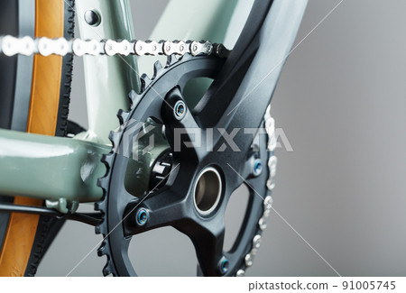 The leading star of a bicycle with a connecting rod and a chain close-up 91005745