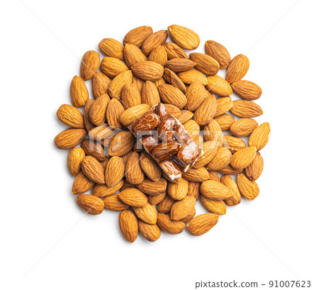 Almond nuts and sweet mini almond bar isolated on white background. 91007623